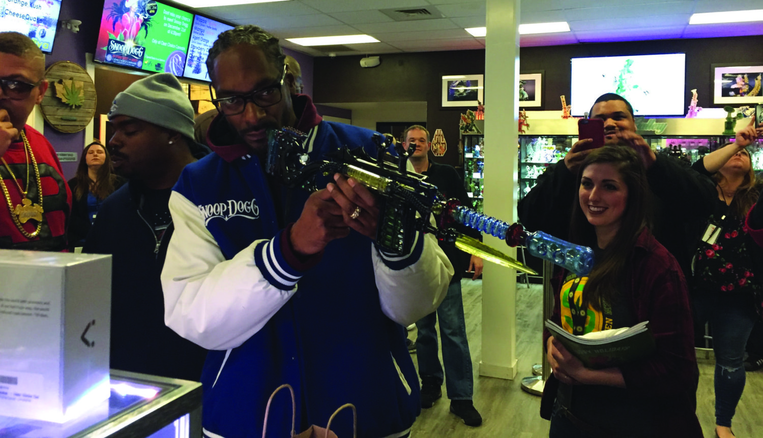 Snoop Dogg, one of the many entertainers with ties to the marijuana industry, checks out a glass gun-pipe during a visit to Clear Choice Cannabis in Tacoma, Washington. 
