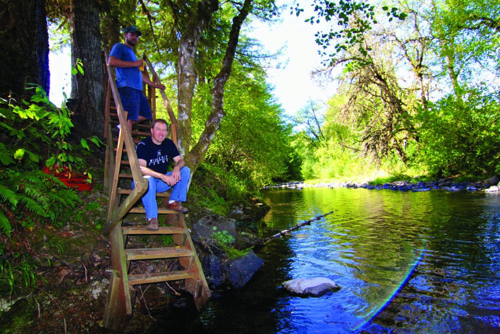 Spence and Jessup on the banks of Winberry Creek, which cuts through the farm's property. 